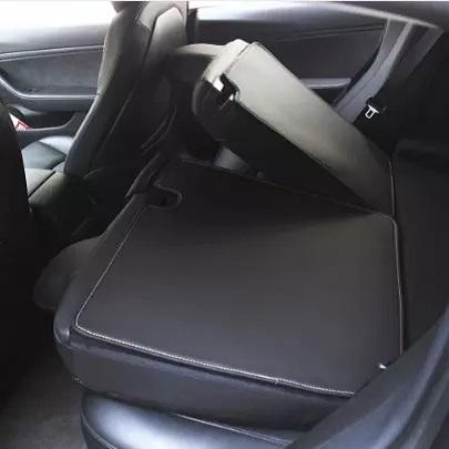 Inside of a Tesla model 3 showing our back seat protectors applied when seats are folded 